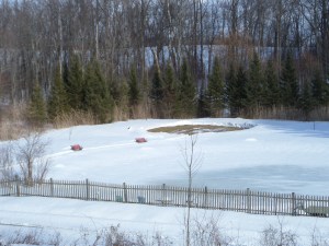 Still Point labyrinth next to the snow covered pond.